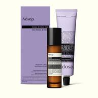 A pump bottle of Solais Replenishing Hand Serum and a tube of Eleos Aromatique Hand Balm together in a carboard box.